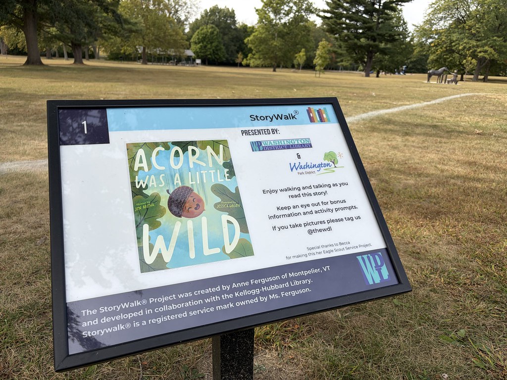 Photo of the StoryWalk in Washington Park featuring the book Acorn was a Little Wild by Jen Arena.